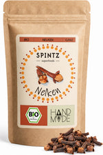 SPINTZ Bio-Nelken im Kraftpapierbeutel mit ganzen Gewürznelken im Vordergrund.