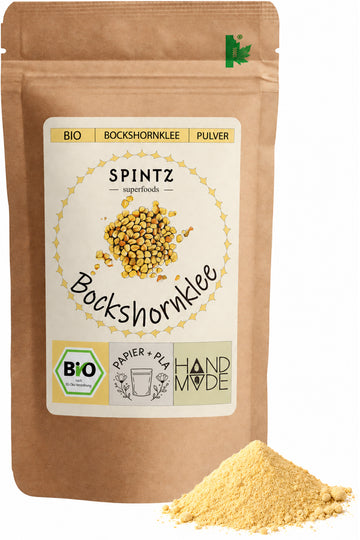 SPINTZ Bio-Bockshornklee-Pulver im Kraftpapierbeutel mit fein gemahlenem, gelbem Pulver im Vordergrund.