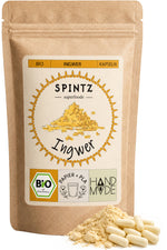 SPINTZ Bio-Ingwer-Kapseln im Kraftpapierbeutel mit hellen Kapseln und Ingwerpulver im Vordergrund.